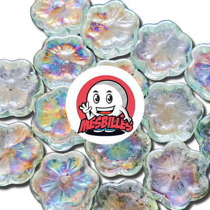 Close-up of an assortment of Fleur Cosmos Cristal 2.5 cm marbles, in translucent Iridescent glass, around the My-Glassmarbles logo.